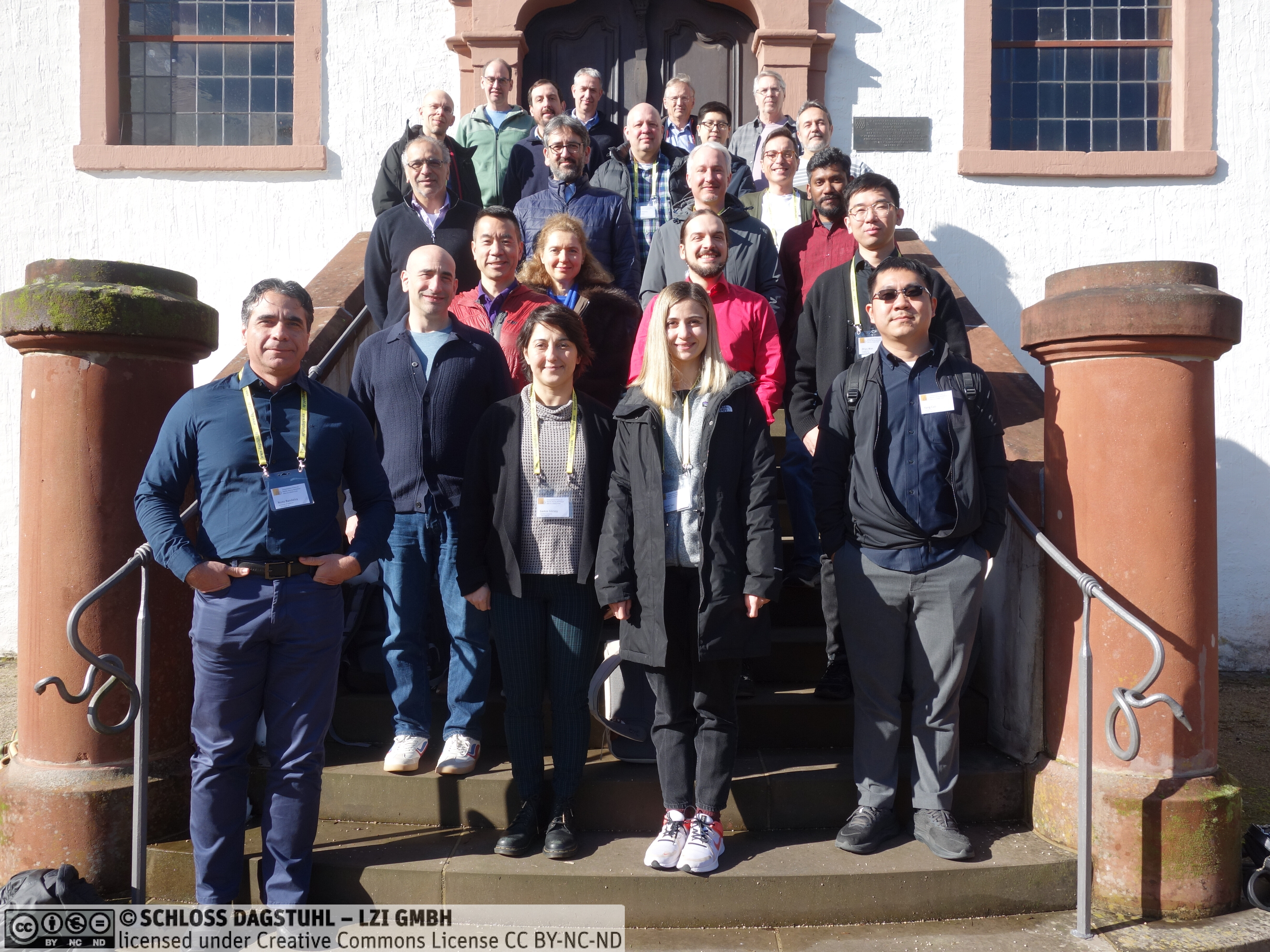 A picture of the participants to Dagstuhl seminar 26082, posing on an outdoor
stairway, under the bright sunlight.